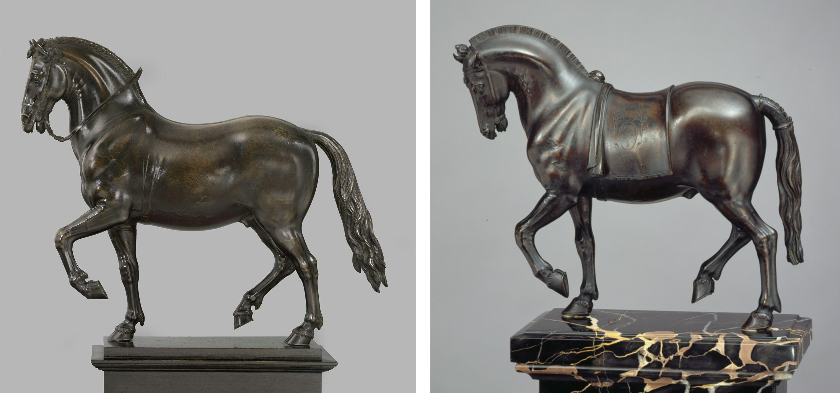 Two almost identical bronze figures of a horse, standing with front left hoof raised.